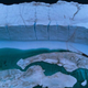 A melting pond is seen inside an iceberg from the Greenland ice sheet in the Baffin Bay near Pituffik, Greenland on July 20, 2022.